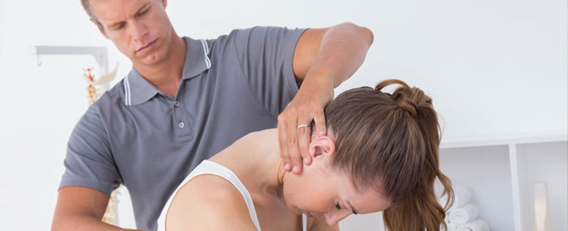 Chiroprator at San Ramon Auto Accident Injury Clinic in San Ramon adjusting female patient's neck to relieve whiplash effects